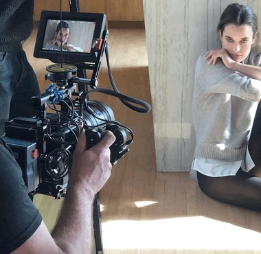 A fashion shoot seen past the camera and its monitor