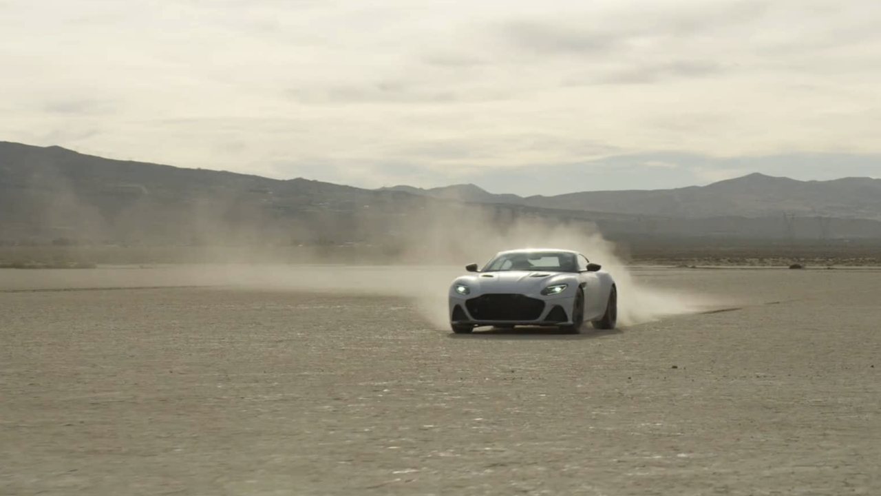 Aston Martin DBS Superleggera kicking up dust on a dry lakebed