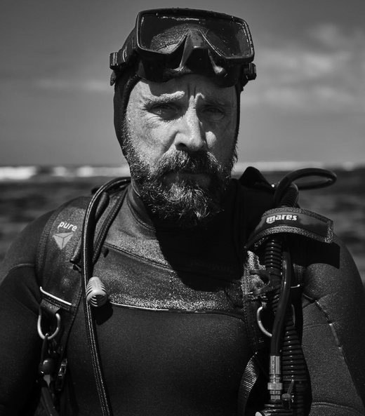 Black-and-white portrait of a diver, mask pushed up