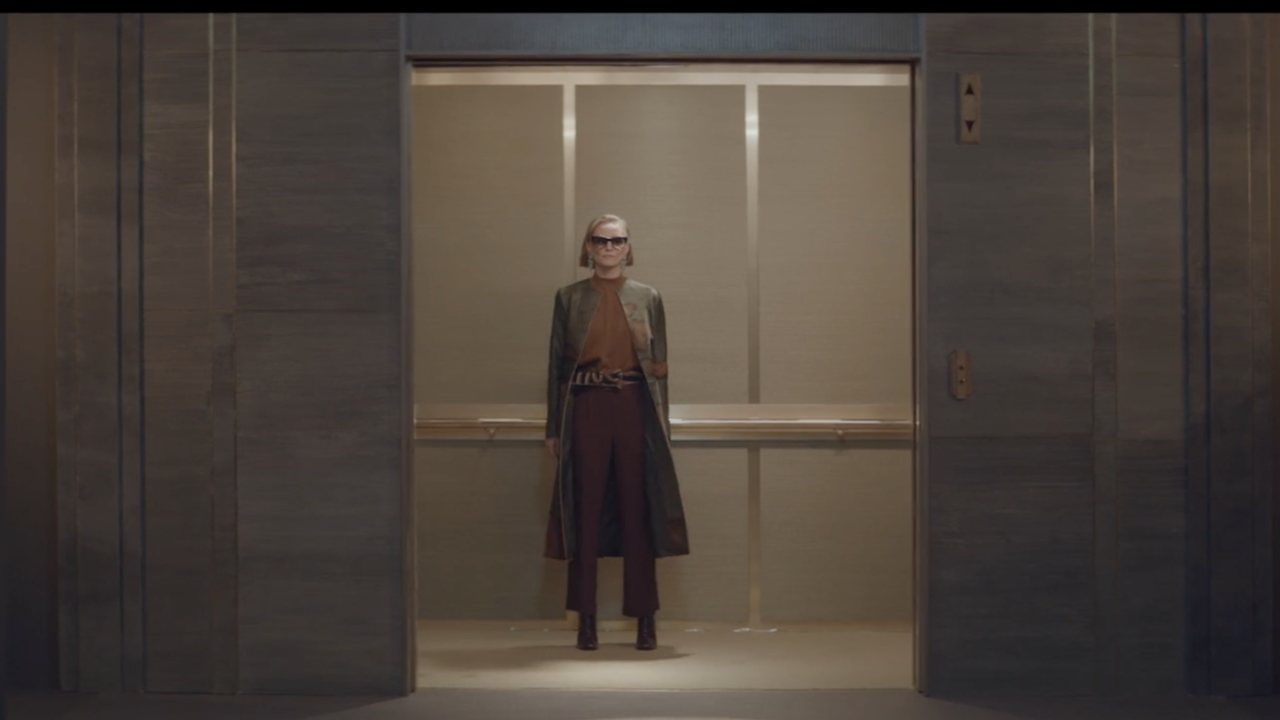 DITA Elevator: a figure alone in an open elevator