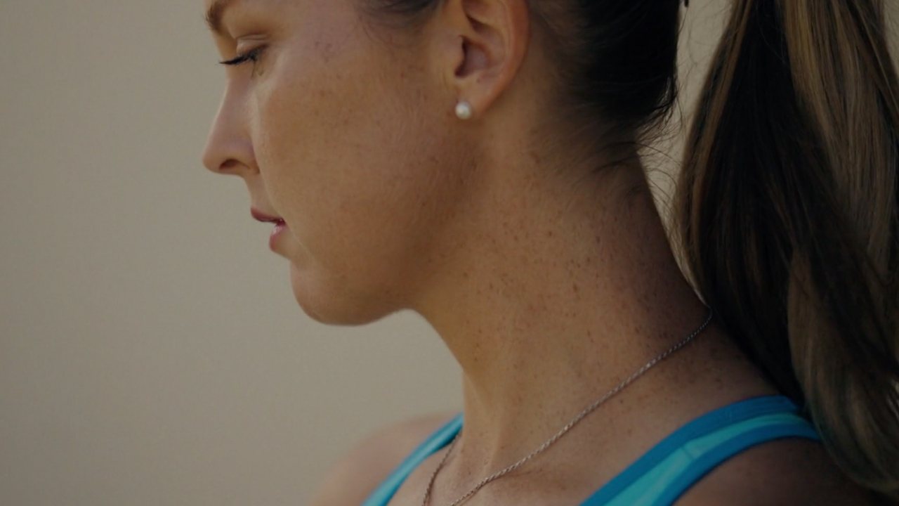 FILA Tennis: close profile of a player, head bowed