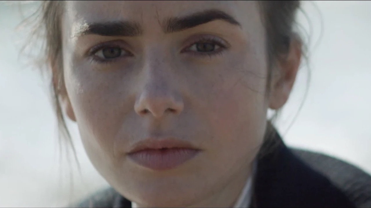 Lily Collins for L’Officiel: a close portrait against a pale ground