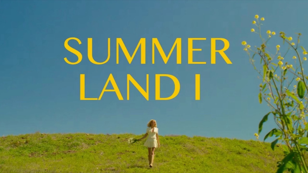 A woman walking a green hill under a blue sky, the film’s title across the sky