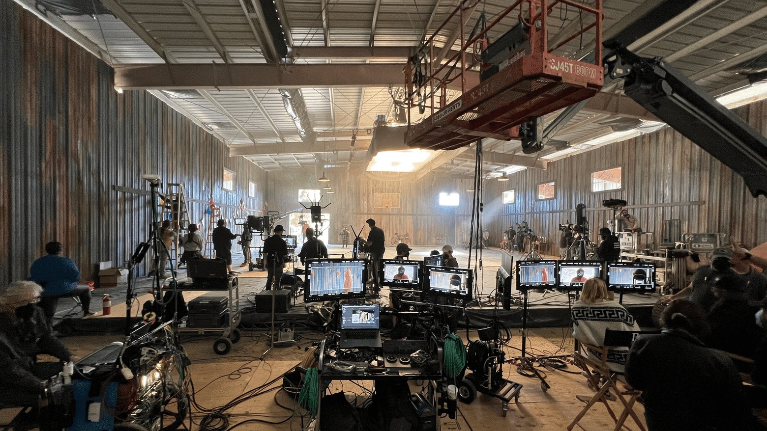 The stage for Steph Curry × NOPE: crew, lights and a row of monitors in a warehouse